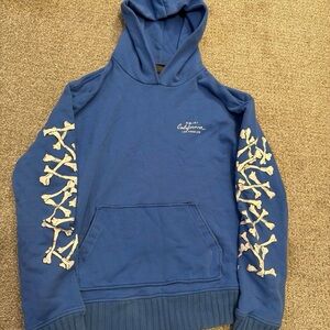 AMIRI Blue Hoodie with Bone Sleeve Design